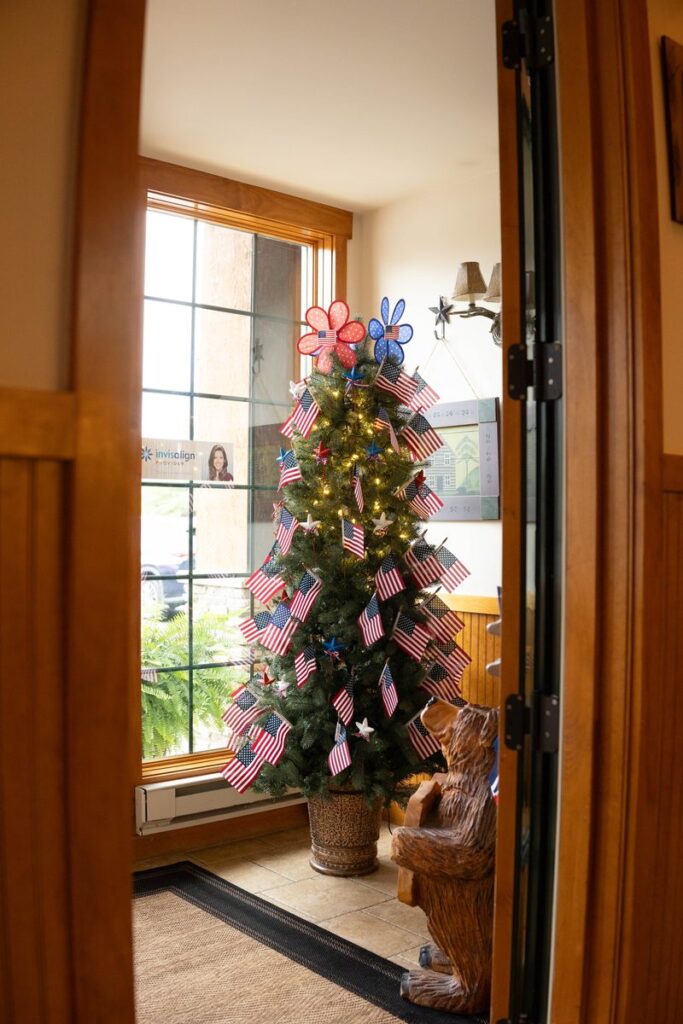 Flag-decorated tree by the front window at Parkside Dental Team
